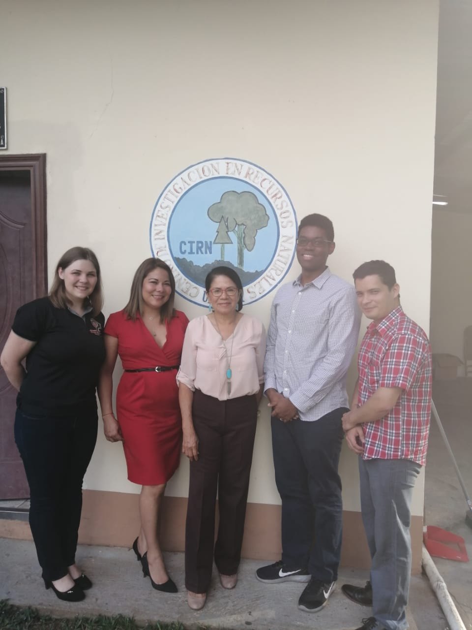 CIRN members in front of the centre's emblem at its UNACHI premises.